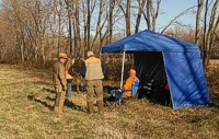 Gunners and bird planters chat while waiting on the sidelines for a brace of master dogs to enter the bird field.