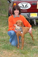 Lexie the Vizsla, with chukar, poses with Mom.