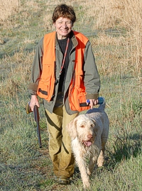 A warm Spinone and smiling handler head out of the Master bird field.