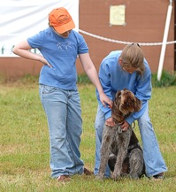 This guy has a two-woman pit crew helping him keep his cool before the treacherous Hot Dog Retrieving event.