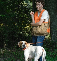 A peaceful moment between Pointer and handler before meeting up with the judges. The handler's eyeing the bracemate, and the Pointer's eyeing the field.