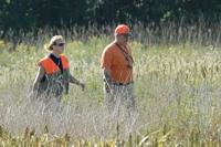 Two handlers trail their dogs into the bird field.