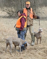 Two handlers and their dogs spend a moment together on the line before the judges send them off onto the Junior back course.