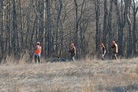 With both dogs simultaneously pointing the same bird, gunners and both handlers quickly approach the situaion. The judges will rule on which dog should work the bird.