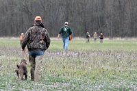 Another team trails the bird man out to the tracking course.